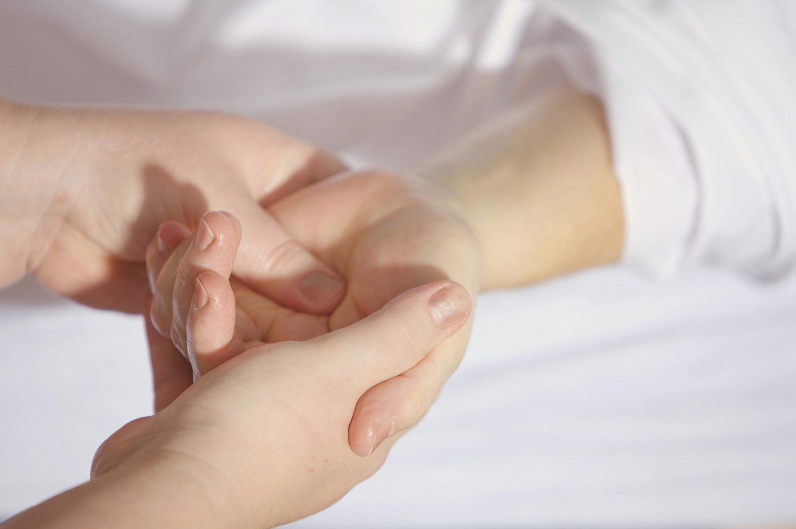 Two people holding hands in a care setting